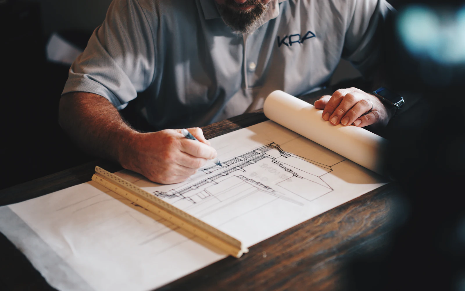 Architect drafting with pencil and ruler