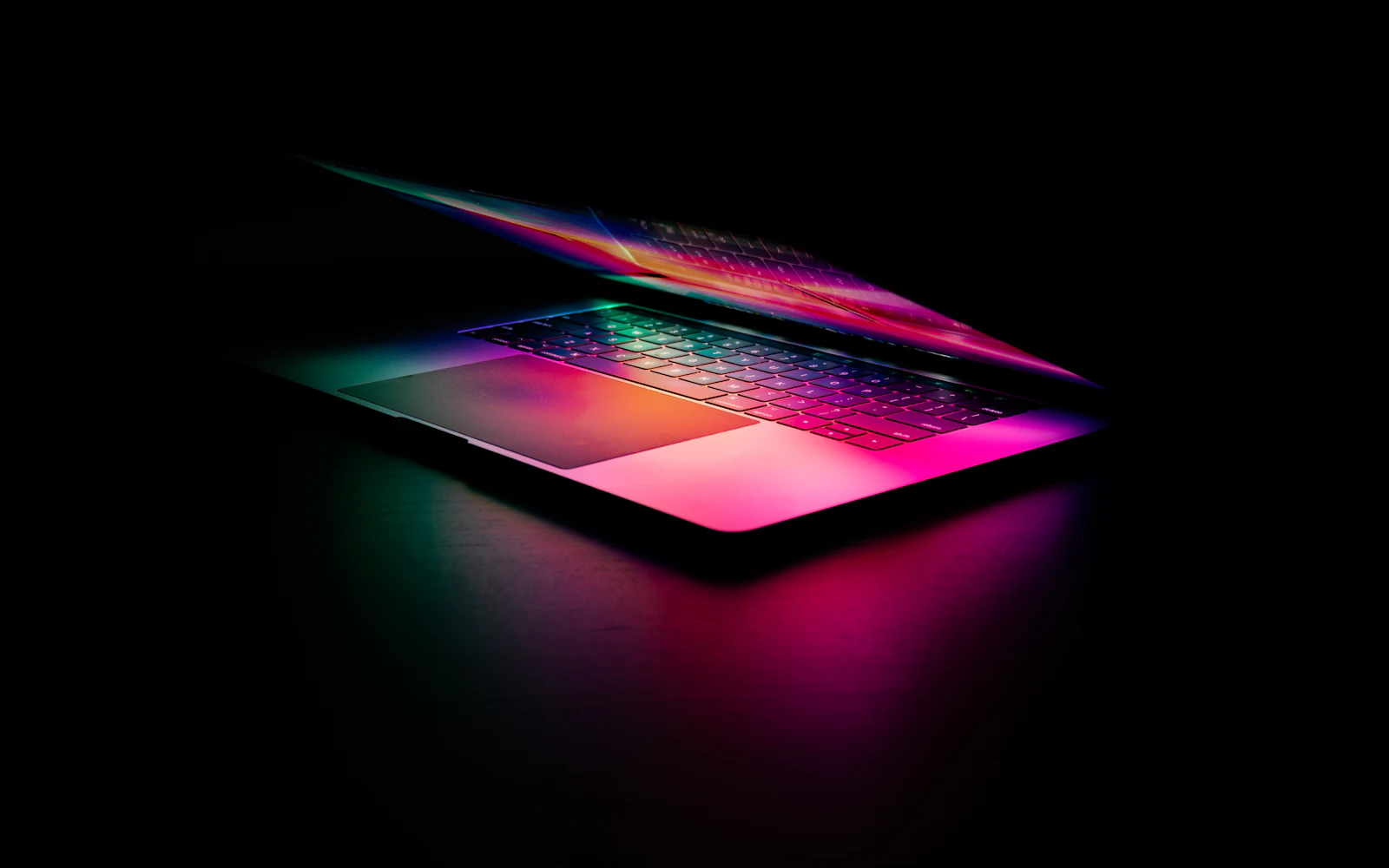 Laptop with glowing keyboard, pink light