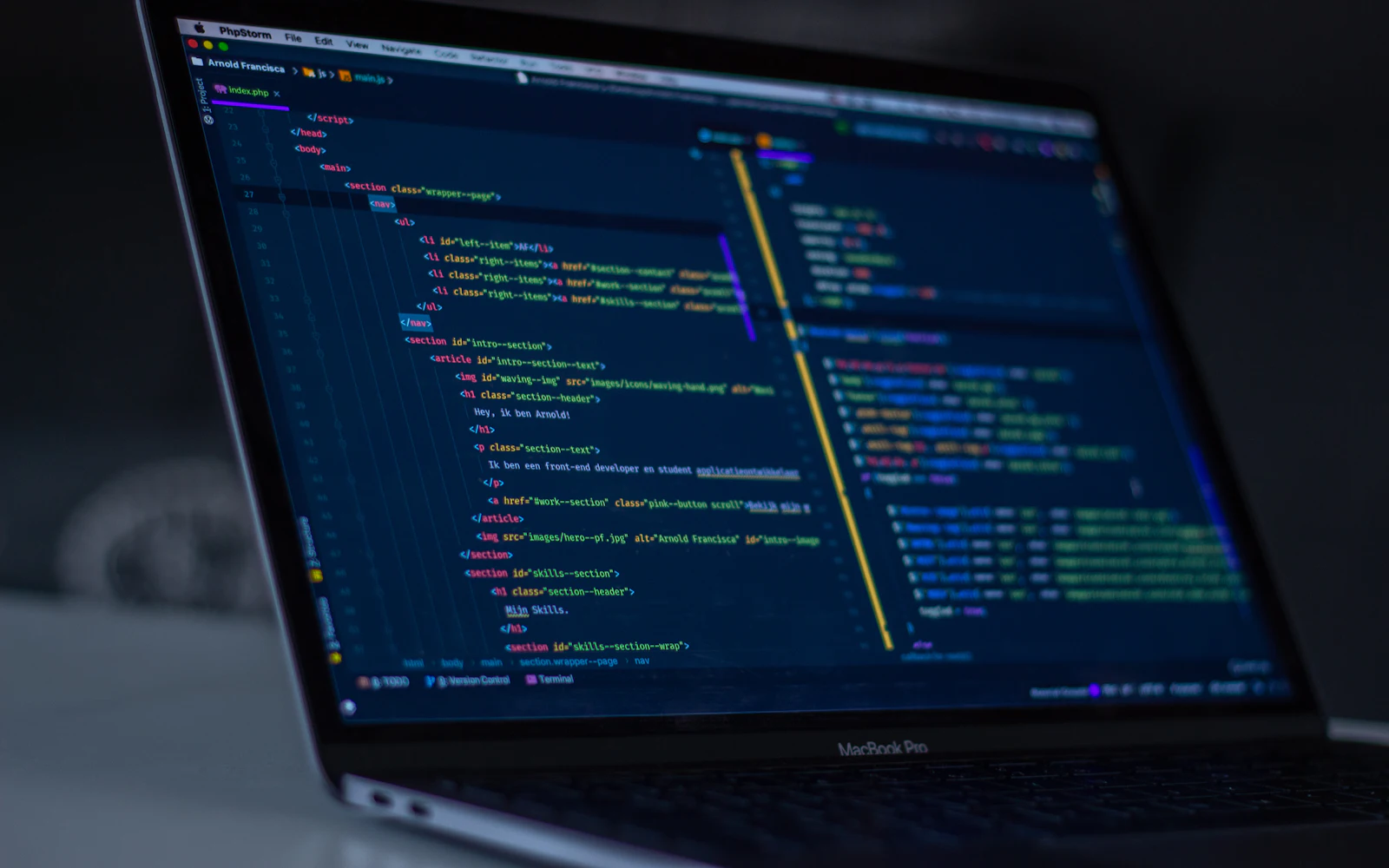 MacBook Pro with programming code on display