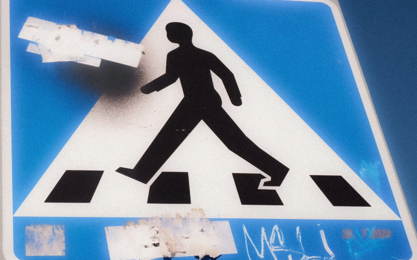 Pedestrian crossing sign with blue sky