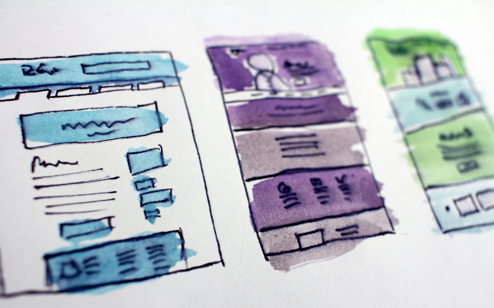 Watercolor wireframe sketches of website layouts